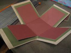 several pieces of pink and green paper on a table