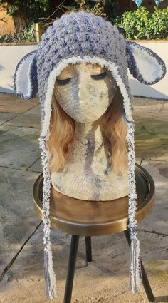 a mannequin wearing a knitted hat on top of a table