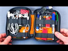 two hands holding an open case filled with assorted items