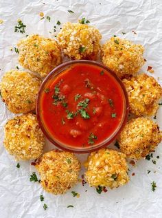 an overhead view of some appetizers in a bowl with sauce on the side