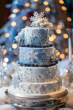 a three tiered cake with snowflakes on it