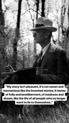 a man in a suit and hat holding a book with an image of trees behind him