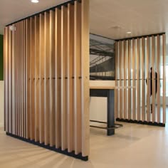 an office with wooden partitions and white flooring