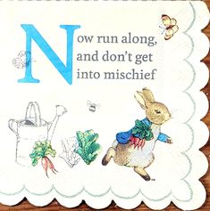 a napkin with the letter n on it and an image of a rabbit holding a watering can