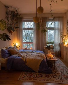 a bed room with a neatly made bed and lots of plants on the windowsill