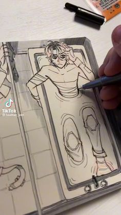 someone is drawing an animation scene on paper