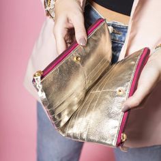 Add some color to your wallet game with this metallic leather wallet! With its multi-colored design, it's sure to make a statement. But it's not just for show - it also has plenty of room for all your cards and cash. So brighten up your daily routine with this fun and functional wallet. 7.5" L X 4.75" W X 1.25" W Modern Gold Wallets For Everyday, Gold Bifold Coin Purse For Everyday Use, Travel Gold Coin Purse With Interior Card Slots, Travel Coin Purse With Card Slots In Gold, Travel Coin Purse With Interior Card Slots In Gold, Gold Wallets With Card Slots For Daily Use, Gold Trifold Wallet With Card Slots For Everyday Use, Gold Bifold Coin Purse With Card Slots, Trendy Gold Wallets For Everyday Use