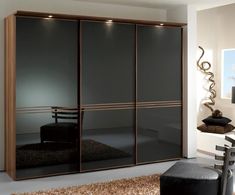 an image of a modern bedroom setting with black and brown color combinations on the doors