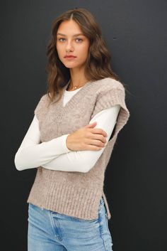 Stay warm and stylish with our Wool Blend V-Neck Sweater Vest. This sleeveless sweater vest features ribbed ends and a v-neck, with stitch detailing down the center. Made from a soft wool blend, it's perfect for layering during the fall and winter, adding a touch of preppy style to your everyday look. 70% Polyester, 22% Nylon, 8% Wool Beige V-neck Tank Top For Fall, Stretch V-neck Vest For Fall, Winter Ribbed Vest, Fall Ribbed Vest For Layering, Sleeveless Fall Sweater Vest, Sleeveless Sweater Vest For Winter Layering, Stretch Sleeveless Sweater Vest For Winter, Stretch V-neck Sweater Vest For Layering, Ribbed Vest For Winter Layering