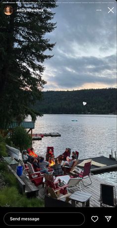 the fire pit is set up on the dock by the water's edge with chairs around it