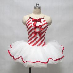 a red and white striped dress on a mannequin headdress with bows