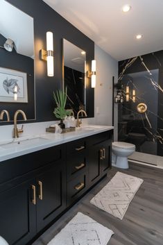 a bathroom with marble counter tops and black cabinets