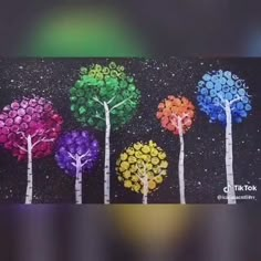 four trees are painted in different colors