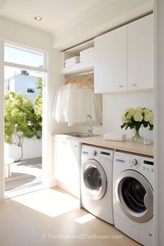 a washer and dryer in a white laundry room with open doors leading to the outside