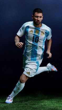 a man is running with a soccer ball in his hand while wearing a blue and white uniform