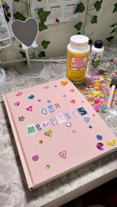 a pink binder sitting on top of a desk next to a mirror and other items