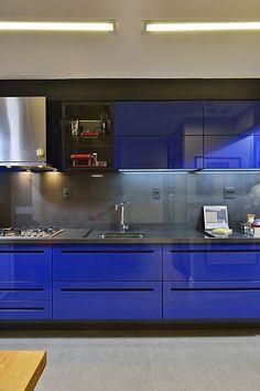 a kitchen with blue cabinets and stainless steel appliances