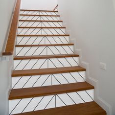 the stairs are made of wood and have white painted treads with black lines on them