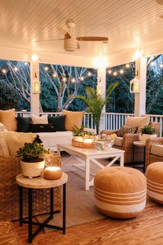 the porch is decorated with lights and wicker furniture