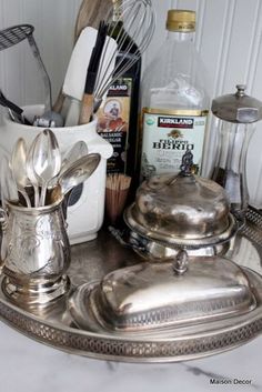 silverware and kitchen utensils sit on a tray