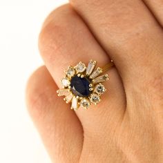 Here is a 18K Yellow Gold ring with a centre Sapphire and in the Gallery there are 6 Round Diamonds and 6 Tapered Baguette Diamonds. Condition: Used (Very Good) Weight: 3.8 grams UK Ring Size: J Please contact for quick resizing! Tested as: 18K Yellow Gold Box: New Gift Box Comments: These Diamonds/Gemstones have not been certified by a laboratory, they have been graded by our own qualified gemologists as fairly and as accurately as possible. Postage: This Ring will be posted via Royal Mail Special Delivery, and should be with you within 3 days of your order. Free postage to the UK! We are a trusted company in Hatton Gardens London, with a wide range stock of high-end watches and fine jewellery. Have a look at our other listings or message us any interest in any item you may be looking for Yellow Gold Cluster Ring With 17 Jewels, Gold Cluster Ring With 17 Diamonds, Yellow Gold Cluster Ring With Brilliant And Baguette Cut, Cluster Yellow Gold Sapphire Ring, Yellow Gold Cluster Ring With Baguette And Brilliant Cut, Cluster Sapphire Ring In Yellow Gold, 14k Gold Cluster Ring With Baguette Cut Center Stone, Yellow Gold Cluster Sapphire Ring, Yellow Gold Sapphire Cluster Ring