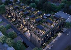 an aerial view of a building with lots of windows and plants growing on the roof