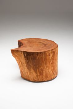 a wooden bowl sitting on top of a white table