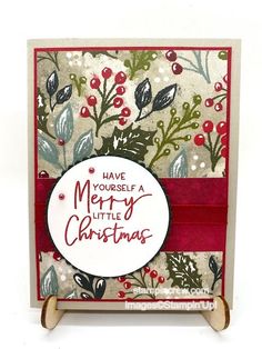 a christmas card with holly and berries on it