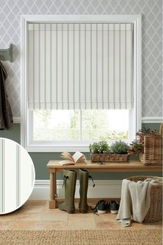 a room with a bench and some shoes on the floor next to a window covered in blinds