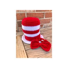 a red and white crocheted cat in the hat hat with matching bow tie