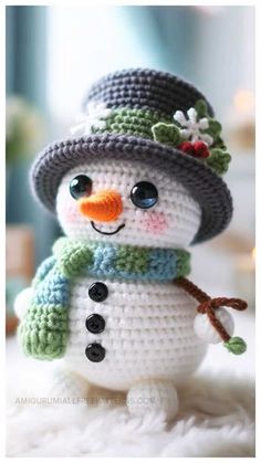 a crocheted snowman with a hat and scarf on it's head