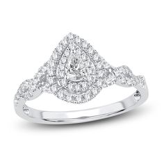 a white gold ring with two pear shaped diamonds on the band and an intricate design