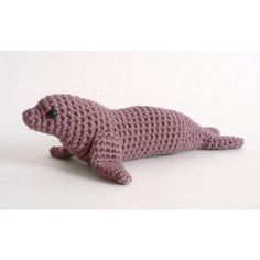 a crocheted sea lion laying on its side