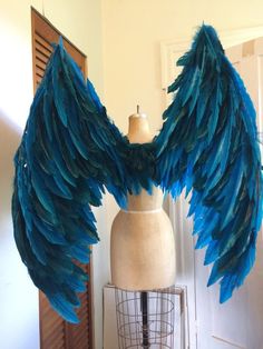 a mannequin with blue feathers on it