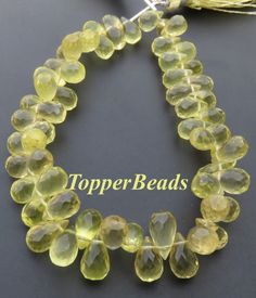 the topper beads are yellow and have large, round glass beads on each strand