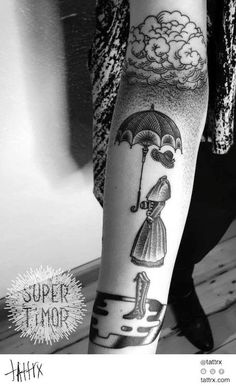 a woman with an umbrella tattoo on her leg