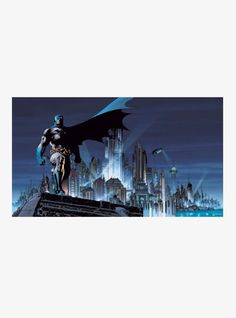 the batman statue stands in front of a cityscape