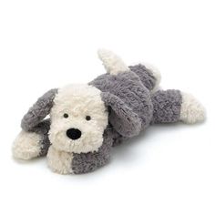 a gray and white stuffed dog laying on its side