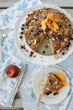 a pie with blueberries, peaches and almonds on top