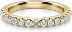 a yellow gold wedding band with five round diamonds on the side and four rows of smaller stones