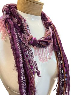 These beaded scarf necklaces are made with Italian silk yarns and mohair and other yarns. A great accent for your summer wardrobe. They are lightweight and comfortable to wear. Measuring 48 inches in length. Colors are a mix of pink and purple. Makes a great addition to any wardrobe, adding that needed splash of color!Comes in a linen pouch Handmade Bohemian Yarn Scarves, Handmade Yarn Bohemian Scarves, Handmade Bohemian Yarn Scarf, Purple Bohemian Scarf, One Size, Purple Bohemian Scarf One Size, Bohemian Purple Scarf One Size, One Size Purple Bohemian Scarf, One Size Bohemian Purple Scarf, Silk Ribbon Jewelry