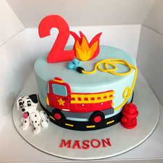 a birthday cake with a fire truck and dog