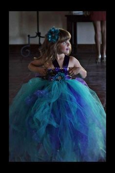 This peacock inspired tutu dress is made with peacock colored tulle in teal, purple and blue. If you would like to add colors that is possible at no extra cost. You can either message me or leave notes in check out. It is adorned with a purple, teal blue and peacock feathered rhinestone embellishment belt. Can be customized to fit any color wedding, with or without the peacock feathers and fabric. This would be perfect for a peacock themed wedding or special. The dress can be worn strapless, but Teal Flower Girl Dresses, Peacock Flower Girl Dress, Purple Tutu Dress, Peacock Flower, Purple Flower Girl Dress, Purple Girls Dress, Peacock Wedding Theme, Tule Rok, Purple Tutu