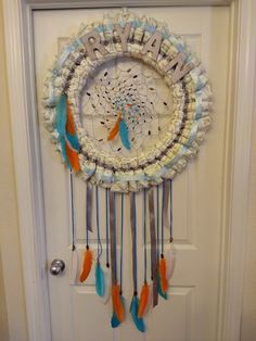 a white door with an orange and blue dream catcher on it