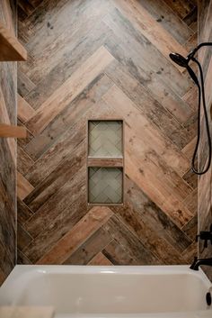 a bath tub sitting next to a wooden wall