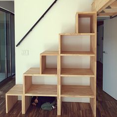 the stairs are made out of wood and have bookshelves