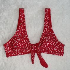 Red And White Flower Bikini Top With Tie Front. Never Worn! Red Cherry Print Swimwear For Spring, Red Cherry Print Swimwear, Red Cherry Print Swimwear For Summer, Red Cherry Print Swimwear For Beach, Red Cherry Print Swimwear For The Beach, Red Floral Print Sleeveless Swimwear, Red Floral Print Swimwear For Beach, Red Floral Print Swimwear For Beach Party, Red Floral Print Swimwear For The Beach