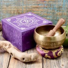 This lovely singing bowl set comes with a well-crafted wooden mallet and a cushion that matches the box, and has vibrant, golden embellishment. The pleasant and rich resonance of this brass bowl is sure to remove any negative energy from your space and reverberate through your body as you soak in its peaceful sounds. The handy box in which it comes also makes a wonderful gift set for loved ones. The bowl measures approximately 4 1/4" in diameter. Peaceful Sounds, Wooden Mallet, Brass Bowl, Cool Box, Singing Bowl, Singing Bowls, Mortar And Pestle, Negative Energy, Bowl Set