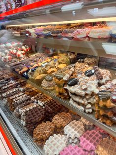 a display case filled with lots of different types of waffles and other pastries