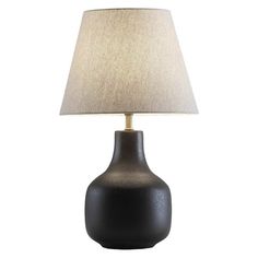 a black table lamp with a beige shade on it's base and a white linen lampshade